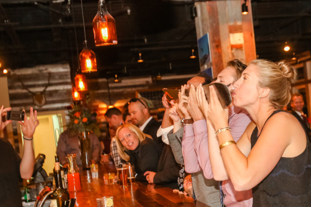 A group taking an après ski shot at the Highlands Ale House in Aspen.