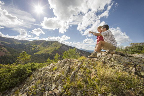 Two people at a scenic overlook while hiking near Aspen.