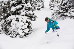 Person skiing on a powder day near the Limelight Hotel Aspen.