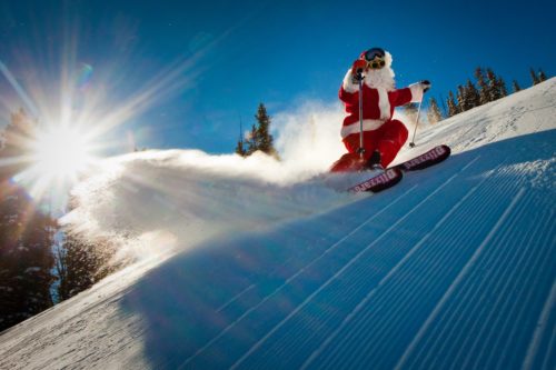 Celebrating the holidays in the mountains - santa skiing